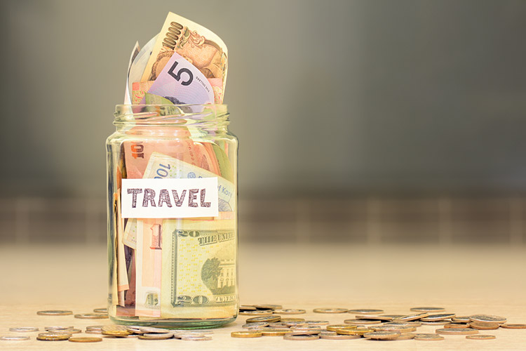 Jar filled with money from different countries around the world.