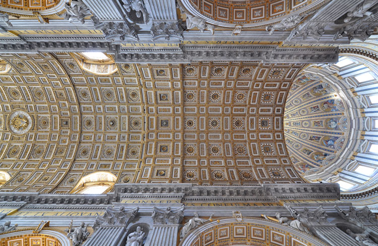 Dome interior and ornate ceiling of the nave in St. Peter's Basilica.