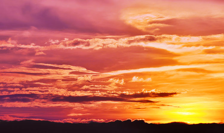 Radiant sunset and wispy evening clouds in Venice.