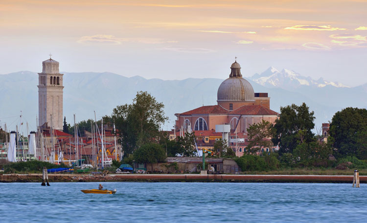 Lovely view of San Pietro di Castello in Venice with the Alps in the distance.