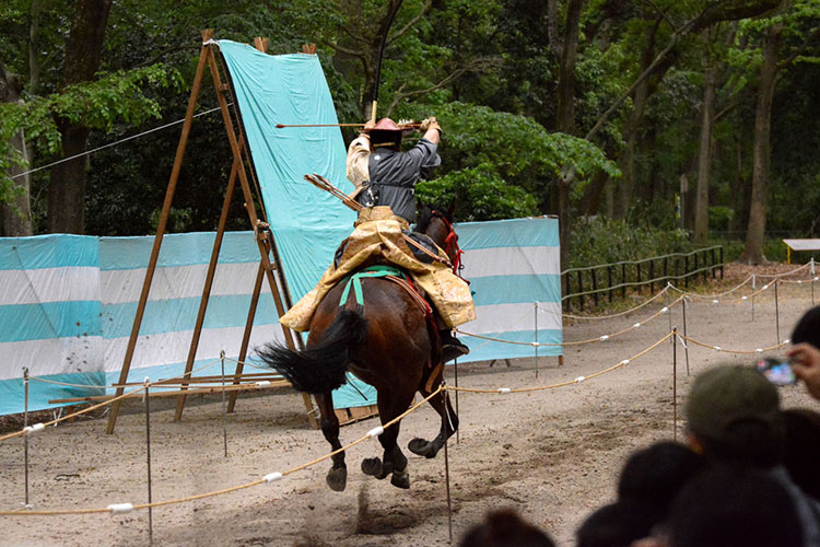A yabusame archer prepares his arrow for an approaching target.
