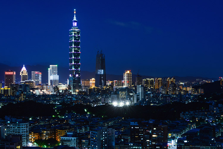 City lights illuminate the skyline of Taipei at night.