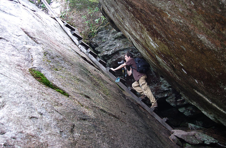 Long wooden ladder through a rock shaft on the Grandfather Trail.