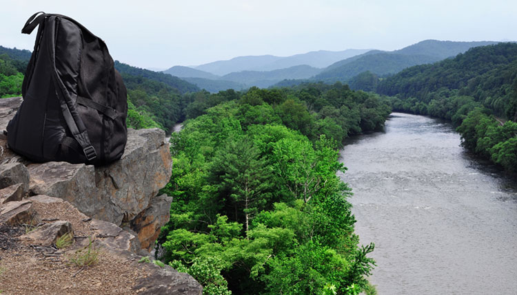 Backpack on a cliff overlooking the French Broad River at Paint Rock in Hot Springs, North Carolina.